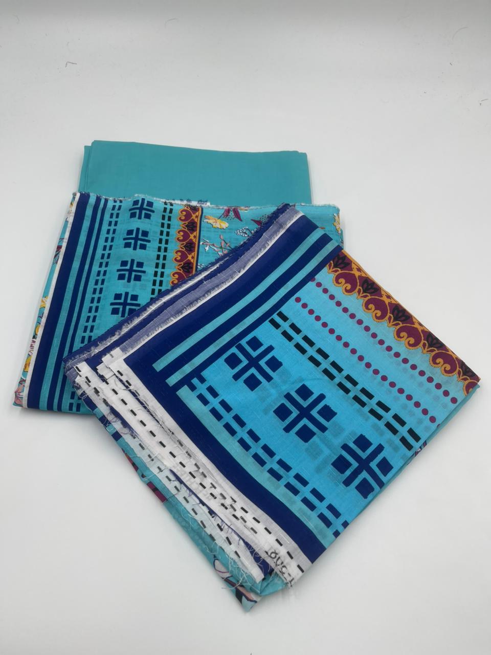 Two folded fabric pieces with blue and patterned designs on a white background