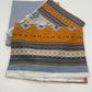 Stack of patterned fabric swatches on a white background